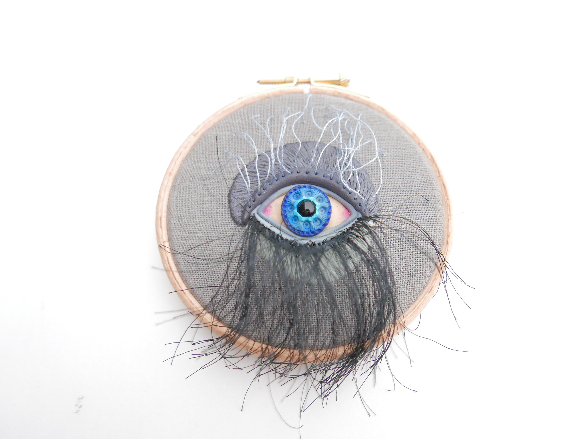polymer clay eye hand embroidered on a hoop