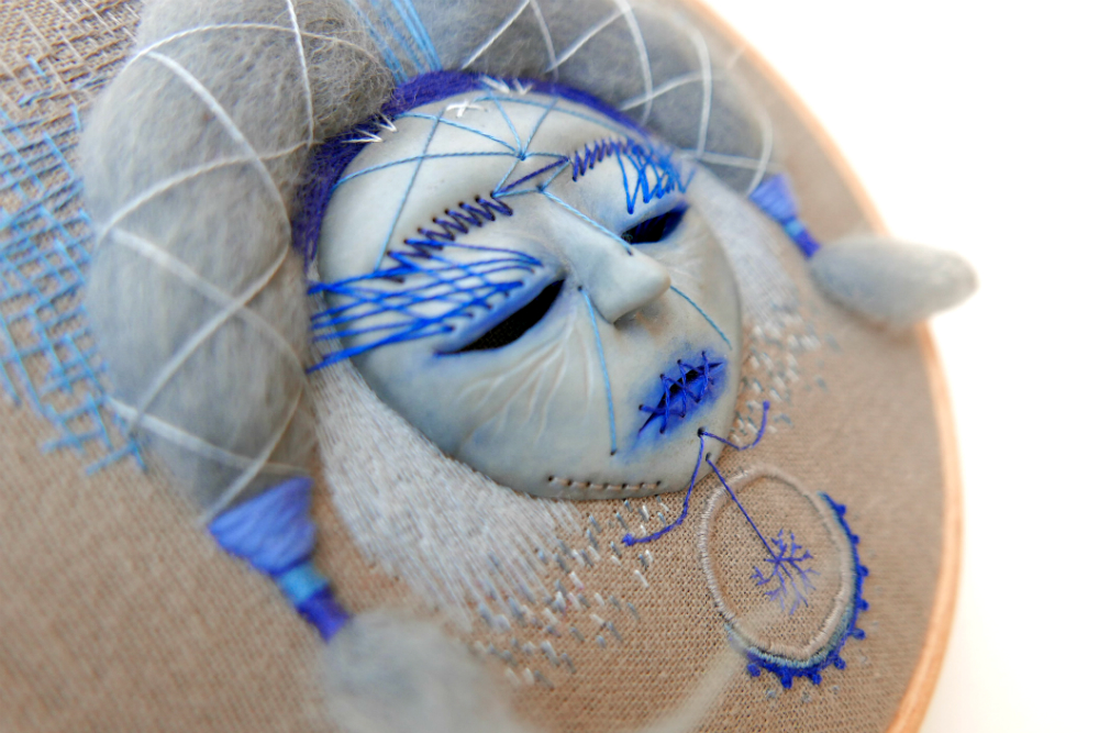 close up of hand embroidered mask