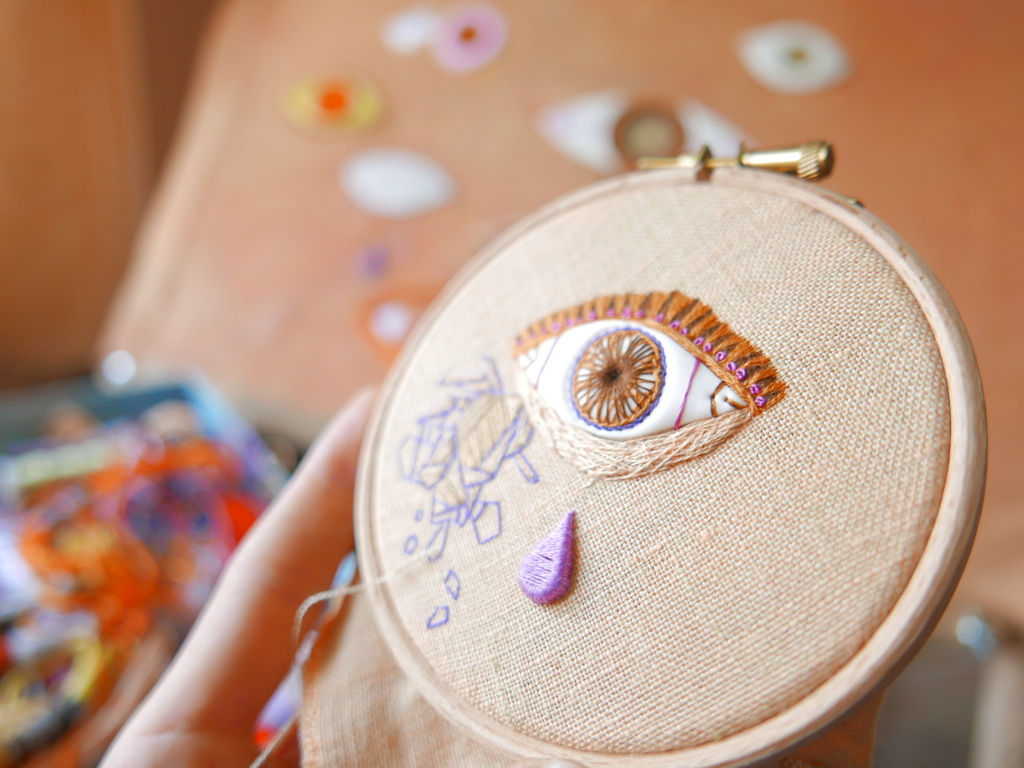 eye and teardrop on a wooden hoop